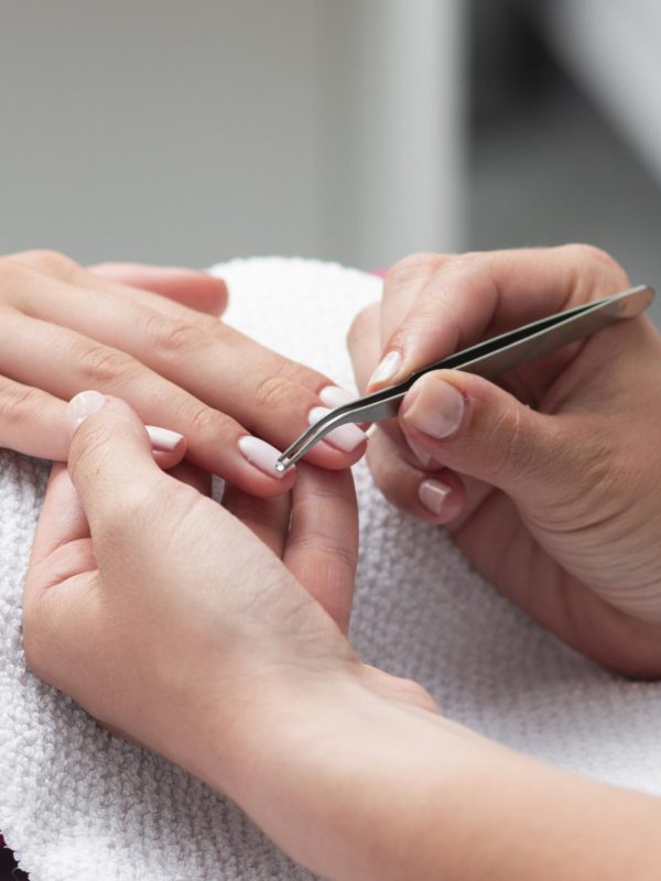 woman-doing-manicure-client-close-up