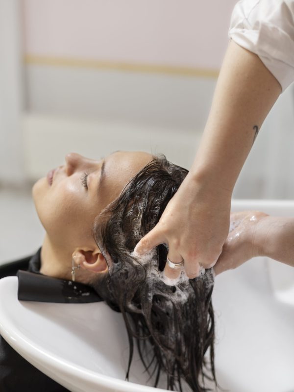 woman-getting-treatment-hairdresser-shop