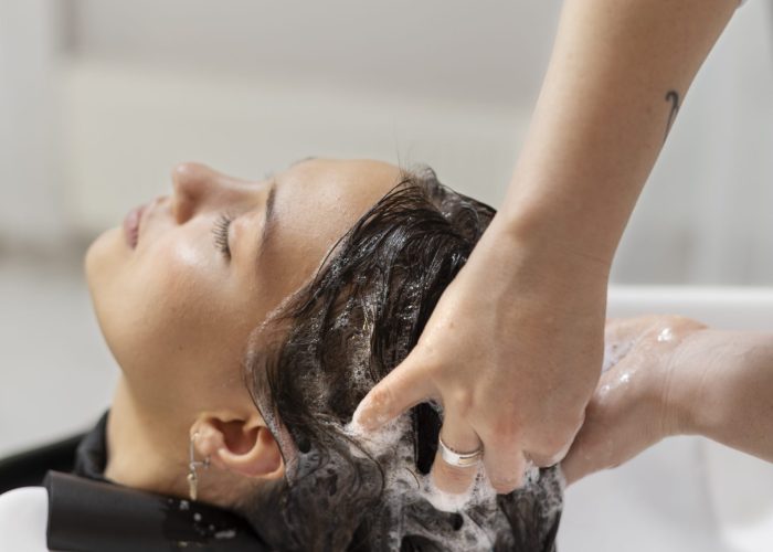 woman-getting-treatment-hairdresser-shop